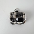 Close-up of black and white checkered earphone pouch with lace trim and silver metal hook - Woolen Black White Plaid