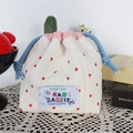 Close-up of knit drawstring bag featuring red heart patterns and embroidered label - Red Heart Stripes