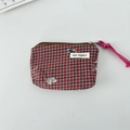 Detail of red and black checkered canvas coin purse with zipper and cartoon animal patch - Plaid Dog