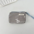 Detail of canvas pouch featuring black and white checkers with a cartoon bear and blue strap - Plaid Bear