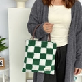 Detail of green checkerboard plush tote bag with brown PU handle and brand label - Plush Checkerboard Green Grid