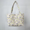 Close-up of quilted floral tote bag showing blue flower patterns and metal snap button - Blue Flower