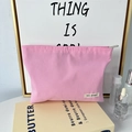 Detailed close-up of pink canvas makeup bag with premium zipper and May Rabbit brand label - Pink