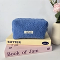 Detail view of royal blue teddy fleece pencil case featuring May Rabbit logo patch - Blue