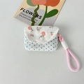 Close-up of floral patchwork fabric earphone case with lace trim and pink wrist strap - Floral Pink + Blue Dots