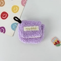 Detailed macro view of soft purple plush headphone case with a brand woven label and lanyard - Small / Purple