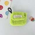 Detail of neon green plush AirPods case with mayrabbit label and hanging strap - Small / Green