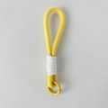 Close-up of a yellow braided rope keychain featuring a round metal spring snap hook - Yellow Lanyard