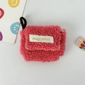 Detail of pink faux shearling plush earphone case with woven label and carry strap - Small / Watermelon red