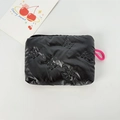 Detail of black glossy makeup bag featuring quilted bow pattern and pink zipper strap - Small Bowknot Black