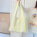 Detail showing colorful vertical stripes and brand label on fabric tote bag - Yellow Purple Stripe