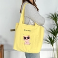 Detail of a yellow cartoon embroidery tote bag with adjustable olive green side drawstrings - Yellow