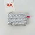 Close-up of silver quilted puffy pouch with glossy metallic finish and pink lanyard strap - Small Square Silver