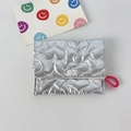 Detail of silver metallic quilted mini pouch with heart patterns and button closure - Large Heart Silver