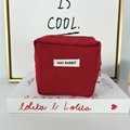 Detail of red canvas lipstick pouch with May Rabbit label and matching zipper closure - Red