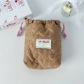 Detail of brown heart quilted drawstring pouch with soft texture and logo tag - Quilted Heart Brown