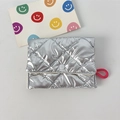 Close-up of silver quilted PU leather coin purse with metallic finish and pink rope handle - Bubble Rhombus Silver