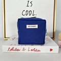 Detailed macro view of the dark blue canvas makeup bag with a secure top zipper closure - Royal Blue