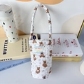 Detailed close-up of a quilted cotton cup holder featuring a cute brown bear print - Cartoon Bear