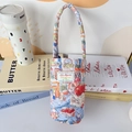 Close-up of quilted cotton cup sleeve with cute rabbit and strawberry prints - Rabbit Family