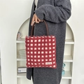 Detail of red and white checkered plush tote bag with brown leather handles - Plush Waffle Red Grid