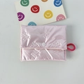 Detail of pink quilted coin purse with bow embossing and white button closure - Small Bow Pink