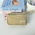 Detailed close-up of khaki corduroy pencil case with May Rabbit woven label and handle - Apricot
