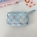 Detail of light blue corduroy pouch with floral embroidery and diamond quilt pattern - Blue Corduroy Quilted Flower