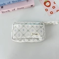 Detail view of double-layer corduroy pencil case with green grid and blue floral patterns - White Corduroy Quilted Flower