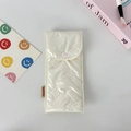 Close-up of cream quilted pencil case with butterfly embroidery and snap closure - Small Bowknot Cream White