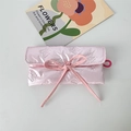 Detail of pink quilted satin pouch with bow accent and elastic loop for storage - Solid Bow Decor Pink