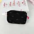 Detail of black corduroy pouch with grey bow pattern and pink zipper pull cord - Black Bow
