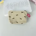 Close-up of floral corduroy coin purse with bow embroidery and pink lanyard - Off-White With Black Bow