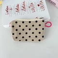 Detailed texture of white corduroy coin purse with black polka dots and pink strap - Khaki Polka Dot