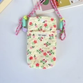 Detail of quilted floral crossbody bag with MAY RABBIT label and green cord strap - Yellow Floral