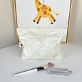 Detail of pearl white quilted makeup bag with elegant bow pattern and zip closure - Small Bowknot Cream White
