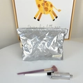 Silver quilted makeup bag with bow pattern and metal zipper on a white vanity desk - Small Bow Silver