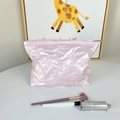 Detailed view of pink quilted makeup bag with bow pattern and metal zipper closure - Small Bow Pink