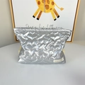Close-up of heart-shaped quilted pattern and metallic silver texture on cosmetic bag - Large Heart Silver