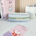 Close-up of pleated stripe pencil case with textured fabric and yellow zipper detail - Green Purple Stripes