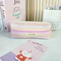 Detail of seersucker textured striped pencil case with zipper and mayrabbit brand label - Pink & Orange Stripes