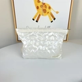Detail of white quilted makeup bag with heart pattern and woven brand label - Large Heart Rice White