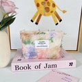 Close-up of floral plush makeup bag with colorful weave and brand woven label - Pink Floral