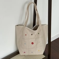 Off-white corduroy tote bag featuring colorful button accents and square stitching - Beige