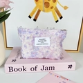 Macro detail of lavender floral print makeup bag in textured plush fabric with zipper - Purple Daisy Flower