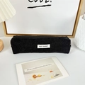 Detail of black corduroy pencil case with zipper and white May Rabbit logo label - Black