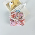 Detailed close-up of pink floral fabric earphone pouch with lace trim and metal clip - Pink Floral