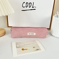 Pink corduroy pencil case detail with white MAY RABBIT label on a cozy desktop - Nude Pink