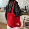 Minimalist red nylon tote bag with Beyou Merci label shown in a lifestyle kitchen setting - Red (beyoumerci Label)