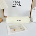 Close-up of cream corduroy pencil case texture with May Rabbit label on a desk - Creamy White